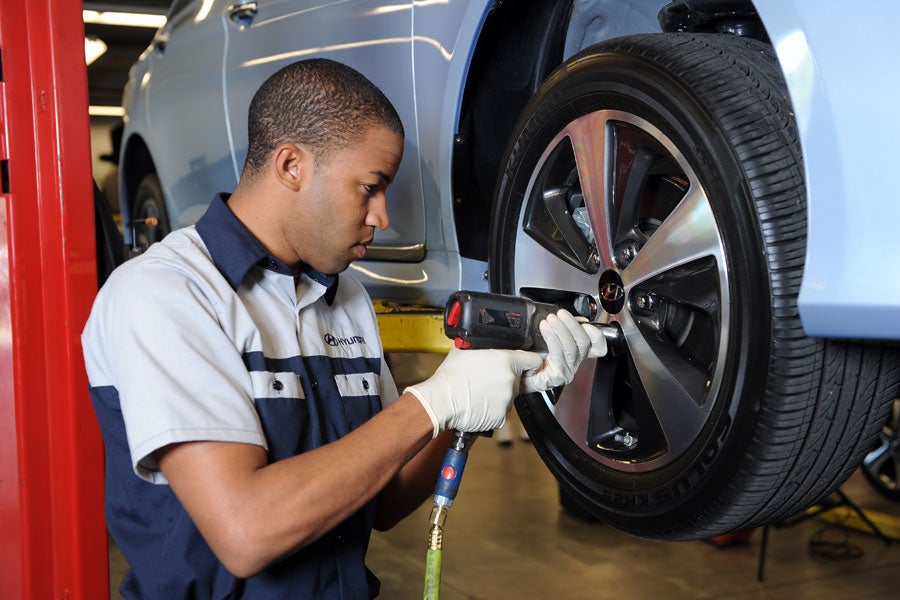 Service mechanic working on a vehicle tire