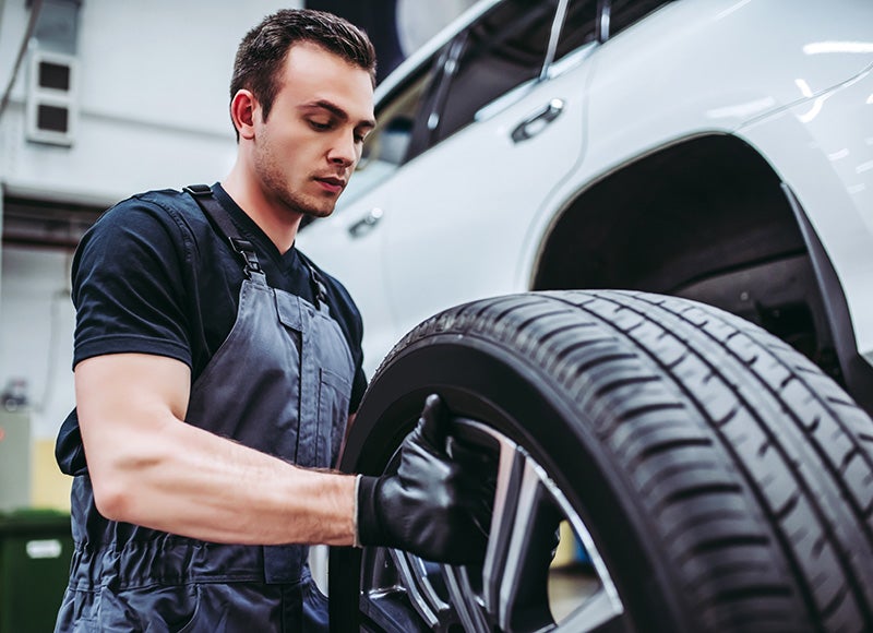 technician holds the tire